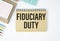 Paper with text fiduciary duty on wood