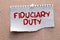 Paper with text fiduciary duty on wood table