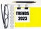 Paper with the text TRENDS 2023 a yellow background, glasses, pen, top view, school, education, knowledge, business