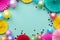 Paper texture flowers with confetti and baloons on green background. Birthday, holiday or party background. Flat lay style.
