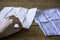 Paper tissue and a cotton handkerchief. Female hand grabs a paper tissue