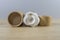 Paper tubes with white cotton disks inside on wooden table. Recycle concept as example of reusing plastic free cardboard