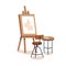 Paper on wood easel, chair, table with art supplies. Creative workplace, drawing on canvas, paints, artistic stuff