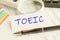 Paper with word TOEIC on a table, concept