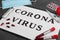 Paper with words CORONA VIRUS, blood samples and medicines on grey stone background