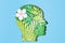 Papercut head with with green leaves inside. Mental health, psychology, memory, logic, green thinking, ecology idea