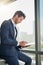 The paperless exec. Shot of a young businessman using a digital tablet in a modern office.