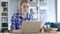 Paperwork, young woman typing on laptop and working on documents