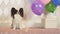 Papillon dog celebrates birthday with gifts balloons and soap bubbles