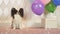 Papillon dog celebrates birthday with gifts balloons and soap bubbles
