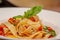 Pappardelle or Linguini pasta in tomato sauce lies on a plate