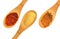 Paprika, garlic, and cinnamon spices on three wood spoons isolated on a white background