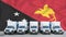 Papua New Guinea flag in the background. Five new white trucks are parked in the parking lot. Truck, transport, freight transport
