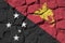 Papua New Guinea flag depicted in paint colors on old stone wall closeup. Textured banner on rock wall background