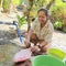 Papuan girl cleaning red fish