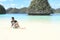 Papuan girl training yoga on beach in Wayag