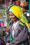 Papuan woman in a bright yellow turban on the market in Wamena