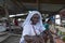 Papue woman sells me some bananas, Sorong, Indonesia