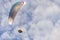 Para glider in fight, hovers in cloudy blue sky
