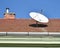 Parabolic antenna on the roof of a house