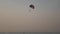 Parachute activity at tropical beach at sunset. Calm sea waters and. Beach recreations with parachute. Towing a