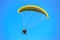 Parachute glider flying in blue sky