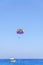 Parachute skiing vacation on blue wave sea and big clean sky
