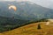 Parachute skydiver flying in clouds at top of mountains with ama