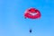 Parachute tandem in a blue sky near sea beach