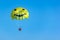 Parachute tandem in a blue sky near sea beach
