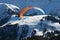 Parachuter above the snowy slope in the Alps