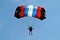 Parachuter, skydiver jumping and skydiving in parachute of black red blue white colours on parachuting cup, extreme sport