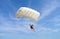 Parachuter, skydiver jumping and skydiving with white color parachute on parachuting competition, extreme sport