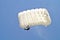 Parachuter, skydiver jumping and skydiving with white color parachute on parachuting competition, extreme sport