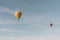 Parachutes flying up in the air during daytime