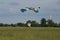 Parachutist with Blue Parachute against Clear Blue Sky