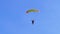 Parachutist flies on a parachute against the blue sky