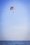 Parachutist flying on multi-colored parachute