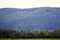 Parachutist jumped from an airplane uses a parachute to land.