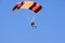 Parachutist jumping on a background of blue sky