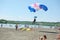 Parachutist landing on the beach