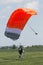 Parachutist running after landing in a field