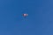 Parachutist silhouette against clear blue sky. Sport, hobby background