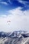 Parachutist silhouette of mountains in windy sky