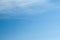 Parachutist soar on colorful parachutes across the boundless blue sky against the background of white fluffy clouds