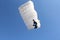 Parachutist with white parachute