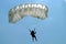 Parachutist with white parachute on parachuting competition