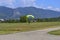 Parachutist with yellow parachute lands on the flight field