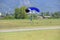 Parachutist with yellow parachute lands on the flight field