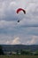 Parachutists approaching ground at cloudy sky